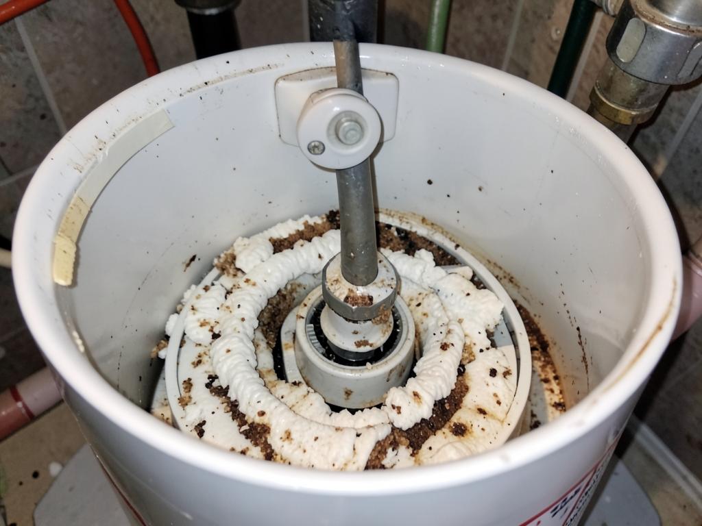 Heavy calcium scale and sediment built up inside a residential water heater tank